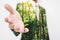 Double exposure, Businessman stretching hand to hand shake with Green trees in the forest. Eco friendly and sustainable business