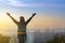 Double exposure Freedom traveler woman standing with raised arms and enjoying a beautiful nature and cheering young woman backpack