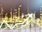 Double exposure graph economy and construction industry oil refinery background.