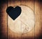 Double exposure of heart shape and wooden circle