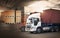 Double Exposure of Semi TrailerTrucks on Parking. Packaging Boxes Stacked on Pallets Loading into Cargo Container. Shipping Trucks