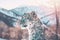 Double exposure of snow Leopard and frozen forest with snowfall and sunny mountains behind