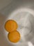 Double fresh egg yolks on stainless background, ingredients for dessert, vertical photo
