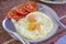 Double fried egg with tomato