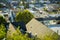 Double gable style rooftops with dark tiles as seen from suburban look out point with sprawling cityscapes in