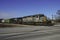 A double header diesel configuration pulls a freight across Broadway Street