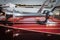 Double horns on vintage wooden speedboat with reflections in wood and other boats and marina in background