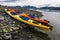 Double kayaks parked on the bay on scenic mountain ocean bay during arctic expedition.