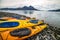 Double kayaks parked on the bay on scenic mountain ocean bay during arctic expedition.