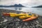 Double kayaks parked on the bay on scenic mountain ocean bay during arctic expedition.