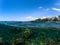 Double landscape with sea and sky. Split photo with tropical island and underwater coral reef.