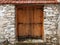 Double-leaf wooden door in a stone wall