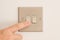 Double Lightswitch on a White Wall being pressed