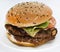 Double meat burger with vegetables on a white background. Delicious cheeseburger on a plate. Meat fast food. A large hamburger