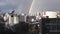 Double rainbow above city