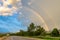 Double rainbow appearing after rain seen from roadside near Lampang province of Thailand