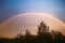 Double rainbow over forest