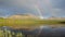Double rainbow over lake and mountains