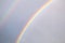 Double rainbow over overcast sky