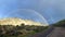 Double Rainbow over winding road to Mammoth Hot Springs in Yellowstone National Park in Wyoming USA