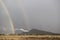 Double rainbow rising over an industrial area