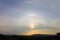 Double ring of sun halo over the mountain during the golden hour of sunrise