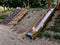 double shiny stainless steel slide on the playground. a hill lined with