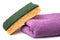 double sided sponge and purple towel on white background