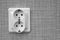 Double socket attached to a gray wall