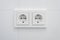 Double socket, new electric plug on white tiles