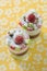 Double soft cake with berry in glasses on yellow b