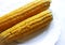 Double sweet corn .on the plate on white backgroun