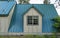 A double window dormer on the first floor with a standing seam metal roof