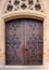 Double wooden church doors set in sandstone archway