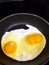 Double yoke egg in fry pan