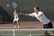 Doubles Player Hitting Tennis ball With Forehand