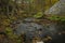 Doubrava river with color rock with moss in autumn day near Bilek village