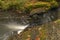 Doubrava river with color rock with moss in autumn day near Bilek village