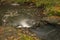 Doubrava river with color rock with moss in autumn day near Bilek village