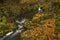 Doubrava river with color rock with moss in autumn day near Bilek village