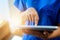 When in doubt, look it up. Cropped shot of an unidentifiable young nurse using a tablet while standing inside a clinic.