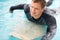 When in doubt, paddle out. Shot of a handsome young man enjoying a surf in clear blue water.