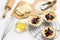 Dough and berries in baking cup on metal trivet.  Whisk and yolk in bowl