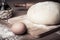 Dough on a board with flour. olive oil, eggs, rolling pin