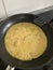 Dough for chickpea pancakes in the frying pan