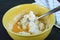 Dough and egg being mixing in the bowl for baking Pao de Queijo or Brazilian cheese bread