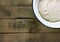 Dough in an enameled bowl on rustic rough wooden background