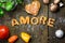 Dough letters and vegetables on rustic wooden table with flour,