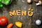 Dough letters and vegetables on rustic wooden table, german word