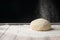 The dough lies on the working surface. With a black background. The power concept.